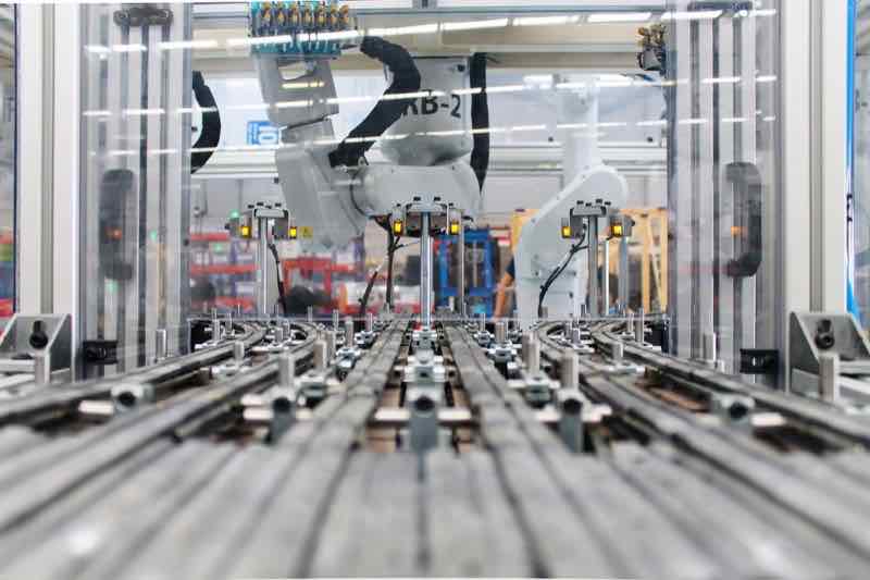 ABB robot performing precision assembly automation at AMD Machines facility