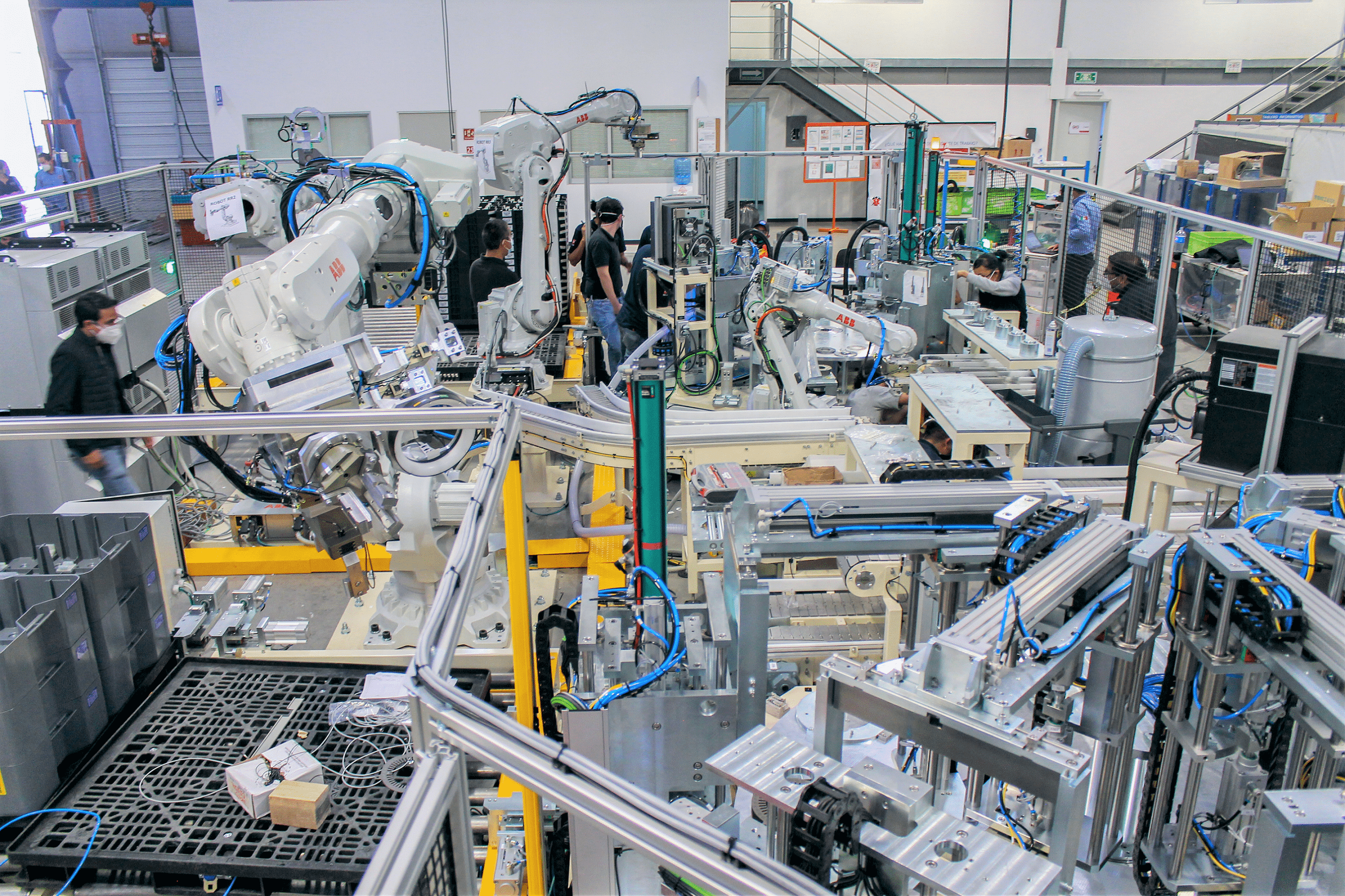 A robot cell being built. It has several auxiliary components like index tables and conveyors to support the automation.